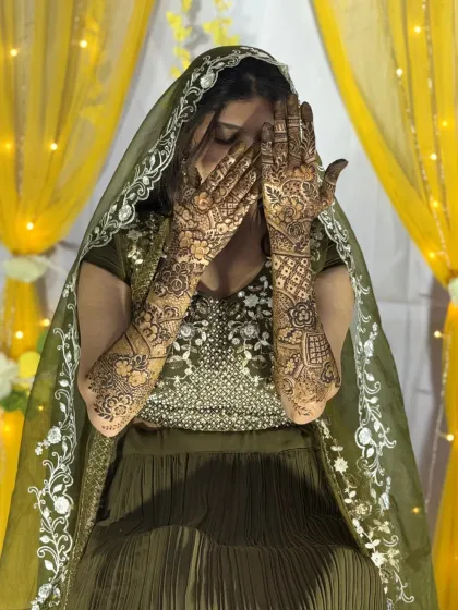This pose captures the elegance of the bride and her intricate, flowing mehendi design, perfect for a modern bridal look.