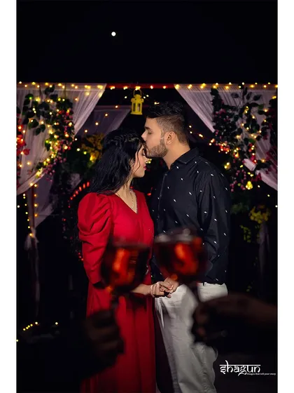 A sweet forehead kiss to seal the deal. This shot, with the romantic fairy light setup in the background, is the perfect end to a successful proposal evening.