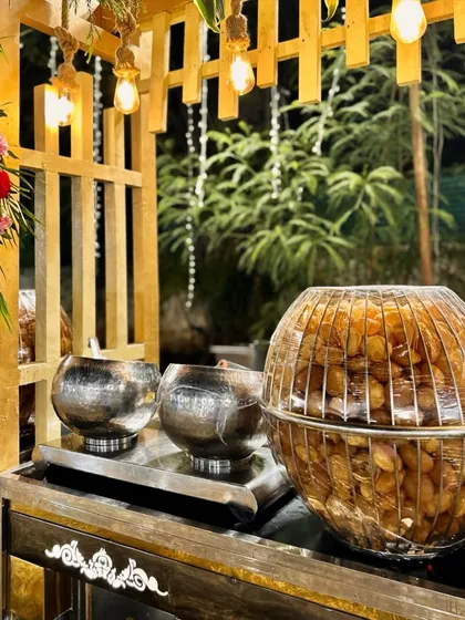 My Pani Puri counter is designed to be both functional and beautiful. This setup uses elegant wooden and metal containers to hold the puris and fillings, adding a rustic charm to the chaat station.