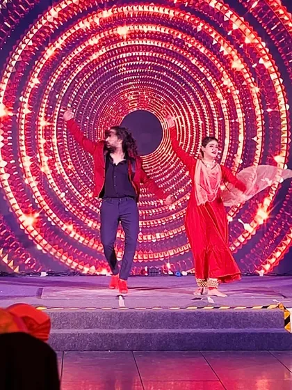 A full-stage shot of a duet, capturing the scale of the production.