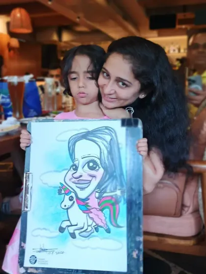 A mother and daughter posing with their unicorn-themed caricature. It's a sweet memory from a family day out.