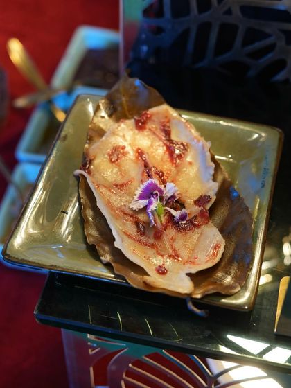 A delicate fish preparation served on a leaf, drizzled with a berry reduction and garnished with an edible flower. This was one of the many gourmet offerings we created for the stars at IIFA 2025.