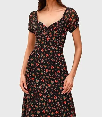 A closer view of the black floral midi dress. The print is delicate and timeless, making this a piece you can wear season after season.