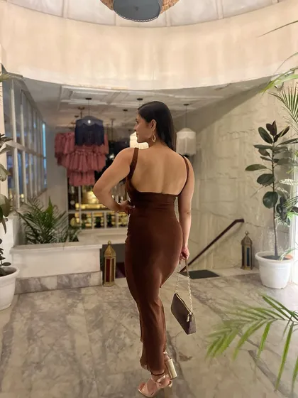 A back pose in my evening dress, showing the muscle I've built.
