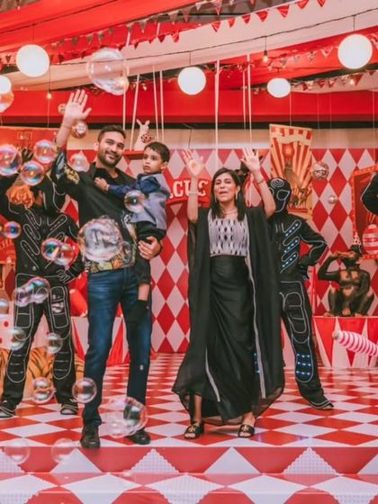 A grand family photo on the fully decorated circus stage, complete with performers. This shot captures the energy and scale of the event, a perfect memento of a spectacular day.