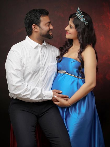 Moments of a lifetime. This sweet couple portrait captures the shared smiles and loving looks between partners as they anticipate their new arrival.