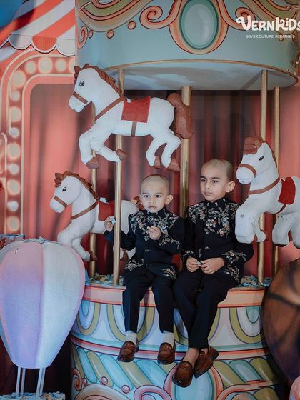 Twinning in tradition and shining in style. These two brothers look effortlessly dapper in our matching bestselling Indo-western outfits at a carnival-themed mundan ceremony.