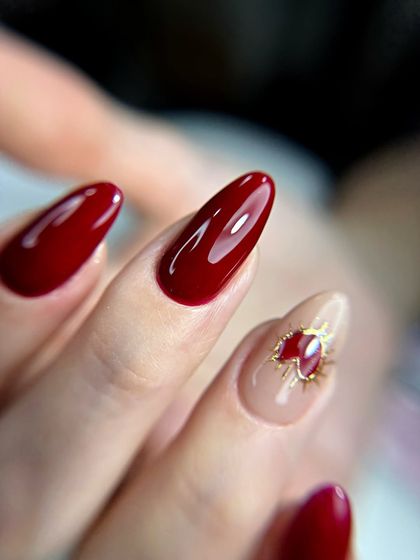 A close-up of the cherry red set, highlighting the glossy finish and the intricate detail on the heart accent nail. This shows my attention to detail even in simpler designs.