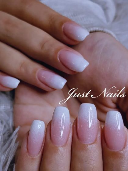 A close-up of a beautiful baby boomer design on square-shaped nails, showing the soft, milky transition.