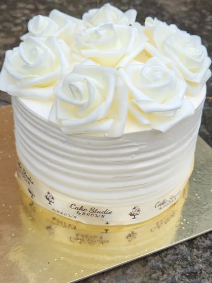 A simple yet beautiful cake with white sugar roses. This design is perfect for someone who appreciates classic elegance.