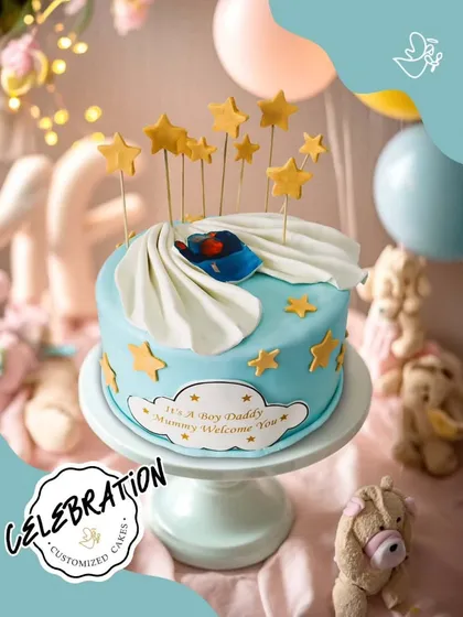 A sweet and dreamy cake to welcome a new baby boy. The blue and white design with stars and a sleeping baby is perfect for a baby shower.