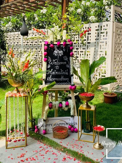 We believe a warm welcome sets the tone for the entire event. For this outdoor Seemantham ceremony, we designed a personalized welcome sign on an easel, surrounded by fresh flowers, traditional banana plants, and brass bowls filled with petals.