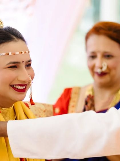 The bride's infectious smile during a candid moment with her family, a testament to the happy and relaxed atmosphere of the day.