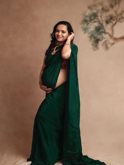Another beautiful shot of this mom-to-be in her green saree. The full-length view shows the graceful drape of the fabric.