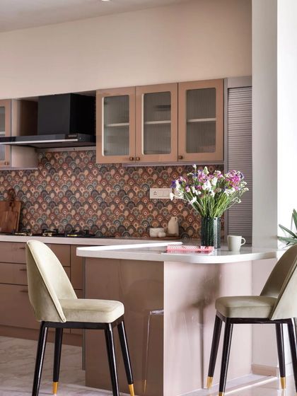 The breakfast counter in this home is the perfect nook for a quick meal or a cup of coffee, connecting the kitchen to the dining area.