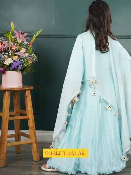 A back view of the sky-blue cape gown, showing how the printed cape drapes beautifully.