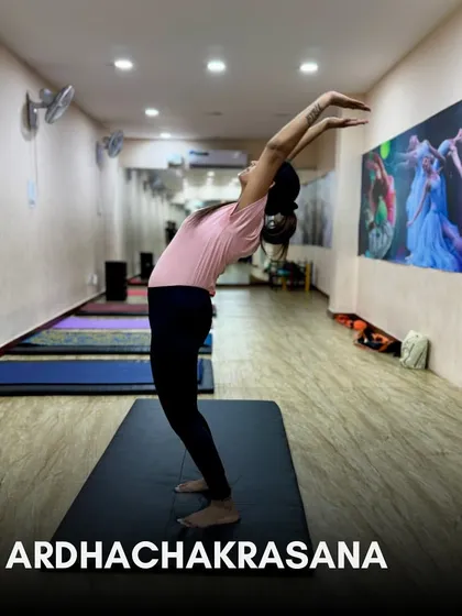 Step 2: Ardhachakrasana (Standing Backbend). This pose helps to stretch the spine and open up the chest, improving posture and flexibility.