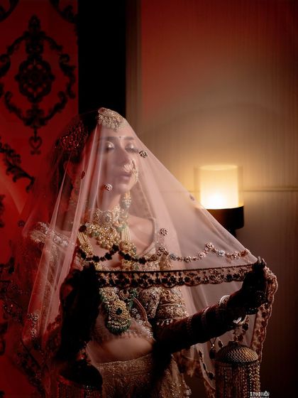 The bridal veil is an iconic part of the look. Here, I am holding my own veil, showing how it frames the face and completes the entire bridal ensemble.