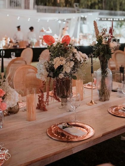 A detailed look at the anniversary tablescape. I used rose gold charger plates, delicate floral arrangements, and black taper candles to create a look that was both modern and timelessly romantic.