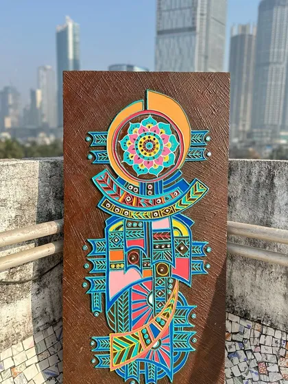 The finished refurbished wooden panel, now a vibrant piece of boho wall decor. The original dark panel was transformed with geometric patterns and a bright, modern colour palette.