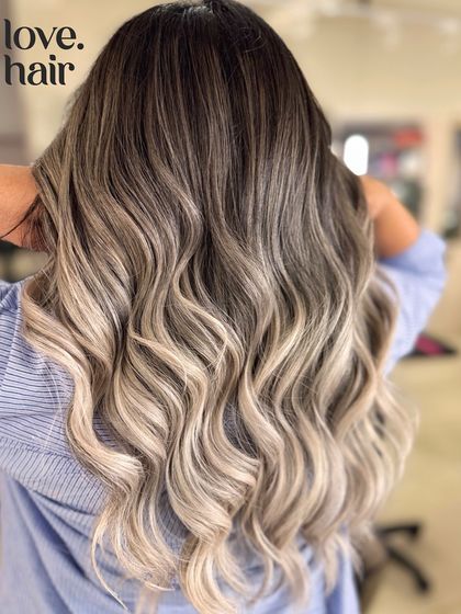 Another back view of the champagne blonde balayage, showcasing the incredible length and health of the hair after a significant lightening service.