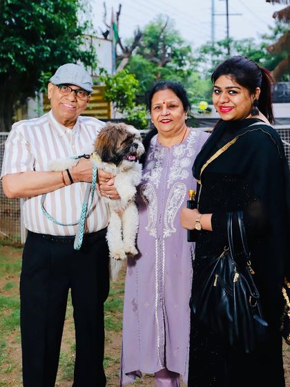 A lovely family photo with their adorable Shih Tzu. Our community of pet parents is the backbone of our daycare.