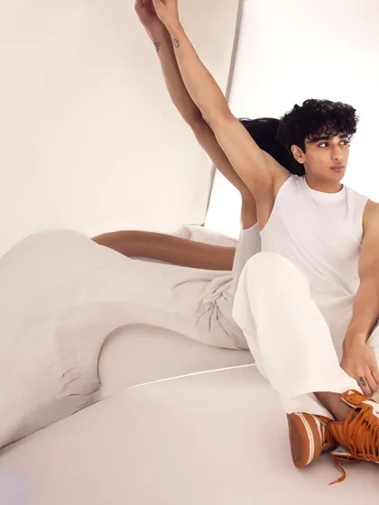An abstract, artistic pose. Even in unconventional shots, the grooming and makeup hold up, looking clean and polished.