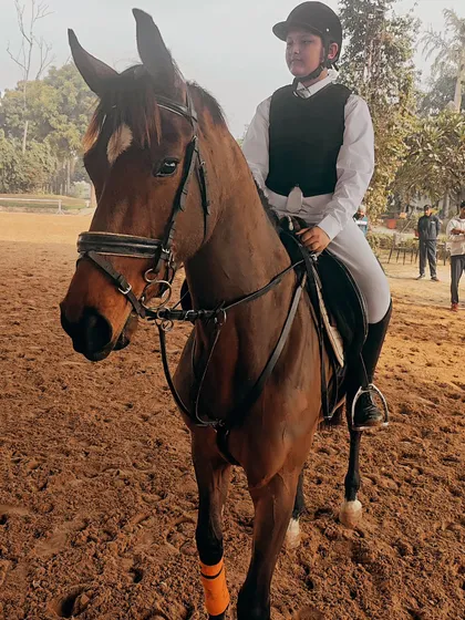 Rider Arnav and his horse Amazing Dream warming up in the arena before an event. Preparation and focus are a critical part of our training.