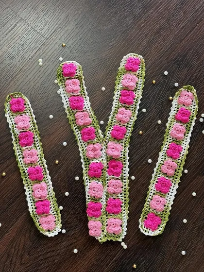 This is one of my custom neckline and sleeve sets, designed to transform a plain kurta or top. The set features intricate pink crochet flowers on a green leafy base, ready to be stitched on for a completely new, designer look.