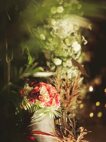 A dreamy, artistic shot of our floral and pampas grass decor at night. The soft focus and bokeh lights in the background highlight the romantic and breathtaking atmosphere we strive to create.