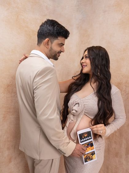 Sharing the first glimpse of their baby. Using the sonogram as a prop is a wonderful way to make the session even more personal.