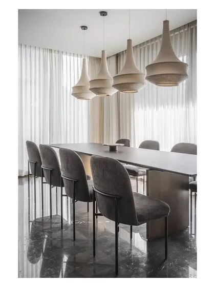 The reflection on the polished dark marble floor enhances the drama and elegance of the dining area in House 111.