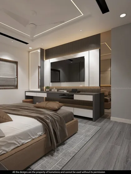 A master bedroom featuring a TV unit with an integrated vanity and dressing mirror. The grey wood flooring and warm lighting create a calm and soothing environment.