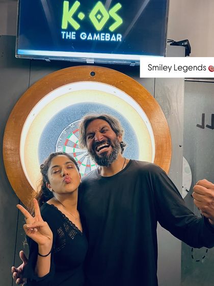 These smiley legends are having a blast by the dartboard. It's a great spot for a photo op after a competitive game during our Karaoke Fridays.