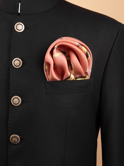 A pink golfer-print pocket square adding a pop of color to a classic black jacket, showing how accessories can personalize an outfit.