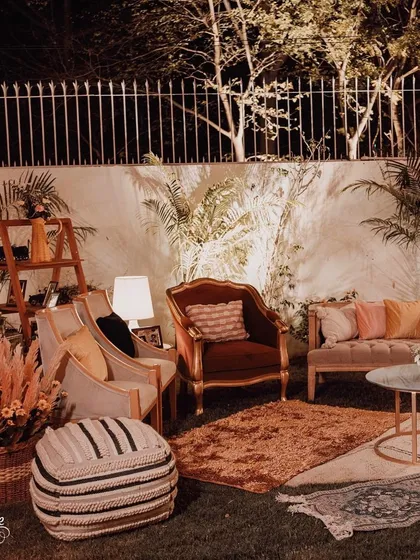 Another view of the comfortable lounge seating, showcasing a mix of armchair styles and textiles to create a layered, residential feel for the outdoor event.
