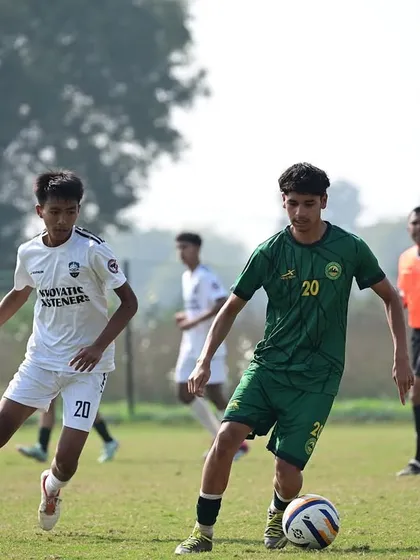 A player dribbling past an opponent in the Dream Sports Championship. Our training focuses on developing individual skill and confidence on the ball.