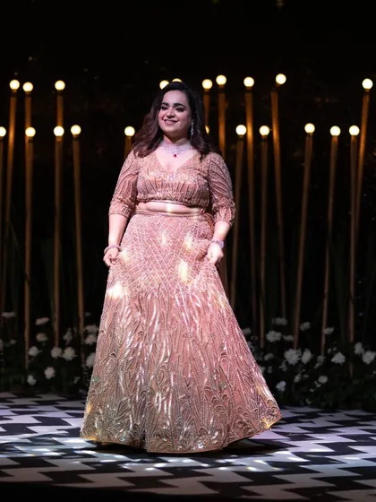 The sangeet look in action. The way the light catches the gold work on this lehenga is just magical. We draped the dupatta over her shoulders so she could dance and celebrate care-free.