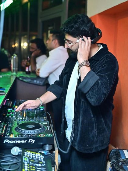 Listening closely to the cue in my headphones at Tipsy Bull. Precision is key to a seamless mix.