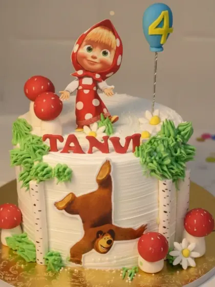 A charming Masha and the Bear cake with a fresh pineapple flavor. The design includes edible birch tree bark details and cute mushroom toppers for a woodland feel.