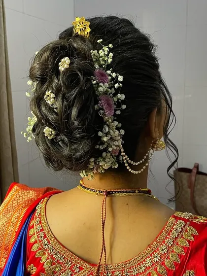Another angle of the beautiful floral bun, a key element of the traditional bridal hairstyle.