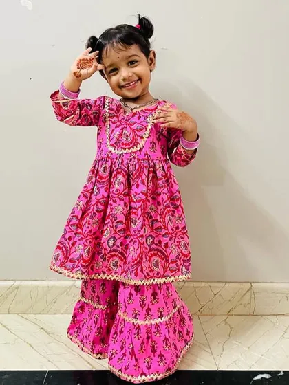 Posing like a little star! Her smile and her cute little mehendi hands are just priceless.
