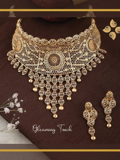 A gleaming touch of elegance. This intricate filigree choker set is a testament to our craftsmanship, offering a delicate yet impactful design that is always in demand.