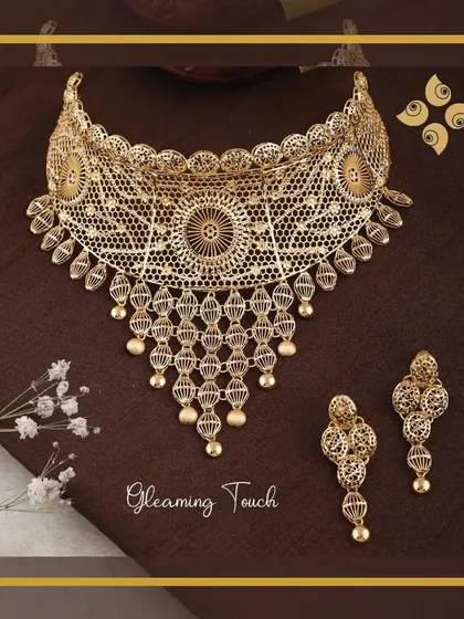 A gleaming touch of elegance. This intricate filigree choker set is a testament to our craftsmanship, offering a delicate yet impactful design that is always in demand.