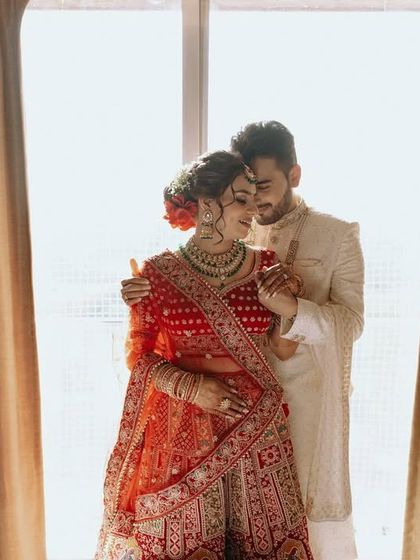 A beautifully backlit portrait of the couple by a window, creating a soft and romantic silhouette.