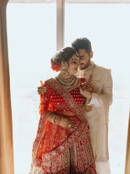 A beautifully backlit portrait of the couple by a window, creating a soft and romantic silhouette.