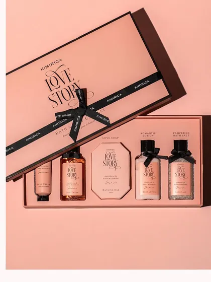 A top-down shot of a luxurious 'Love Story' bath and body gift set. The elegant packaging and neat arrangement convey a sense of premium quality and make it an ideal gift.