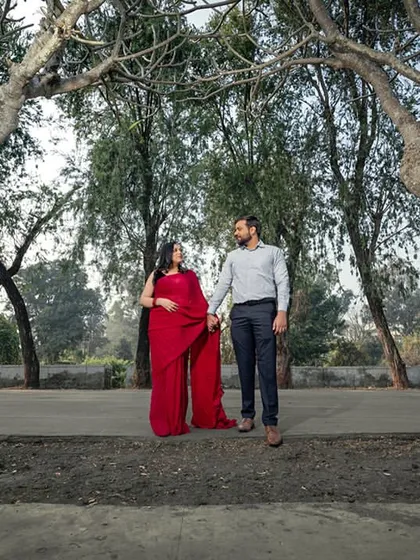 A simple, hand-in-hand walk through a grove of trees. This shot captures a peaceful, everyday moment of togetherness in a beautiful natural setting.