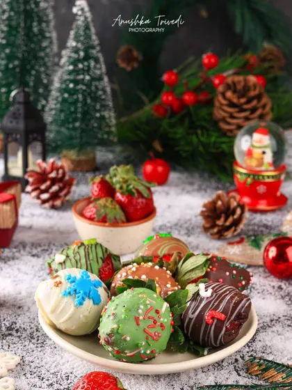 Chocolate-dipped strawberries decorated for Christmas. The dark, snowy background and festive props make these treats look like they're straight out of Santa's workshop.
