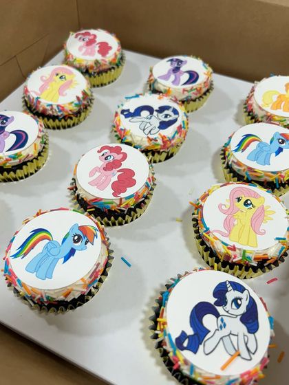 My Little Pony cupcakes for a magical birthday party. Each cupcake features a different character on an edible topper, surrounded by rainbow sprinkles, making them a hit with all the kids.